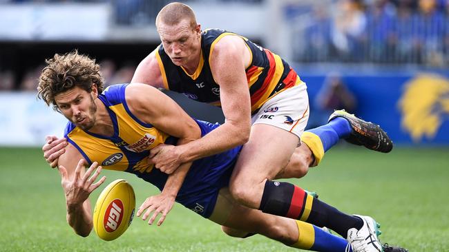 Sam Jacobs brings down Eagles ruckman Tom Hickey. Picture: Daniel Carson/AFL Photos via Getty Images