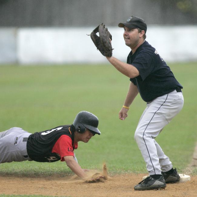 Taka Kume of the Heat beats the pick off attempt to Cubs first baseman Steve Landsberg in the 2007 Cairns Baseball League.