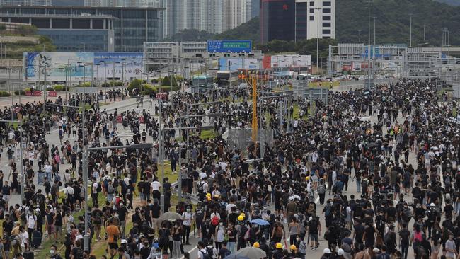 Pro-democracy protesters gather outside the airport in Hong Kong after the express train to the airport was suspended. Picture; AP.