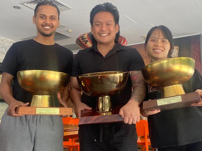 The Chow crew holding up their trio of Golden Bowls after adding the 2024 crown to their mantelpiece, after tying for first with Bamboo Lounge. Picture: Supplied