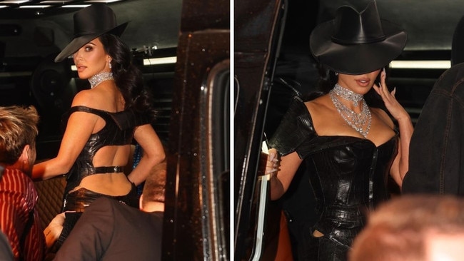 Kim Kardashian commanded attention in an edgy black leather plunge, but it was her top hat and diamond-studded chain that turned heads. Let’s hope she doesn’t lose these diamonds in a pool. Picture: Getty