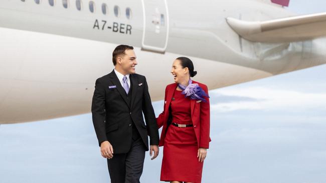 BRISBANE, AUSTRALIA - DECEMBER 04: In this image released on December 12, crew from Virgin Australia stand beside a Qatar Airways Boeing 777 at Brisbane Airport on December 04, 2024 in Brisbane, Australia. A new partnership between the two airlines has been launched which will deliver more value and choice to Australians, providing opportunities to travel to over 100 destinations across Europe, the Middle East and Africa. From December 12, Aussies can book Virgin Australia's new direct services from Sydney, Brisbane and Perth to Doha for travel from June 2025, with Melbourne set to launch later in 2025. These flights will be operated by Virgin Australia using Qatar Airways' spacious Boeing 777s, renowned for their Qsuite Business Class. (Photo by James D. Morgan/Getty Images for Virgin Australia)