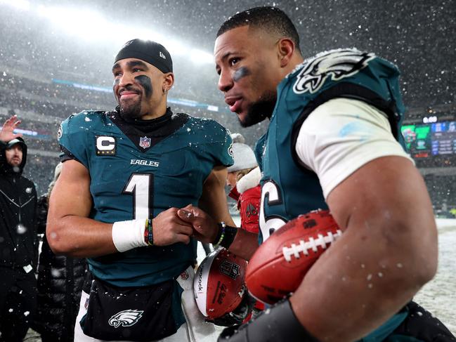 PHILADELPHIA, PENNSYLVANIA - JANUARY 19: (L-R) Jalen Hurts #1 and Saquon Barkley #26 of the Philadelphia Eagles react after defeating the Los Angeles Rams 28-22 in the NFC Divisional Playoff at Lincoln Financial Field on January 19, 2025 in Philadelphia, Pennsylvania.   Sarah Stier/Getty Images/AFP (Photo by Sarah Stier / GETTY IMAGES NORTH AMERICA / Getty Images via AFP)