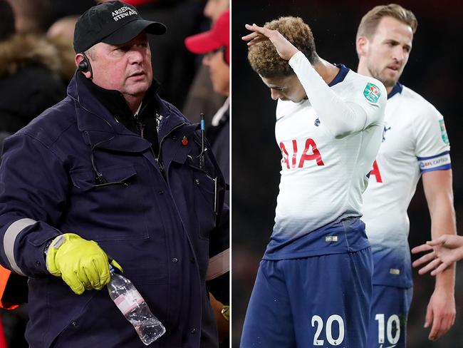 Tottenham midfielder Dele Alli (right) reacts after being hit in the head by a bottle thrown from the stands. A security guard (left) is pictured removing the bottle from the field.