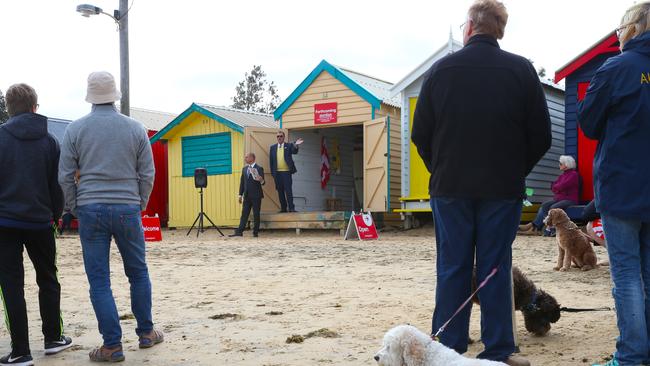 A crows gathers for a bathing box auction. Picture: David Crosling