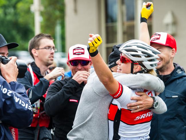 Peta Mullens is embraced by coach Mark Fenner after winning the national road race.