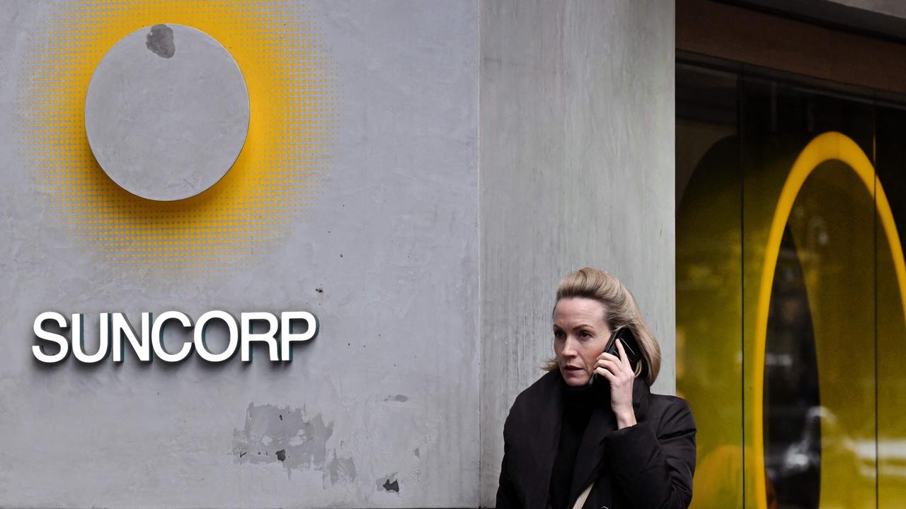 A pedestrian walks past a Suncorp Bank branch in Melbourne.