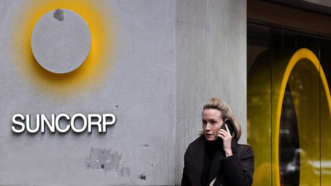 A pedestrian walks past a Suncorp Bank branch in Melbourne.