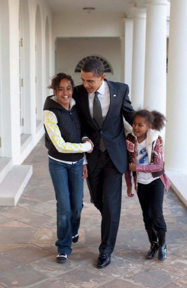 President Barack Obama walk down the Colonnade with his arms around daughters Malia and Sasha at the White House in Washington DC, USA on 5 March 2009. Picture: Pete Souza/The White House