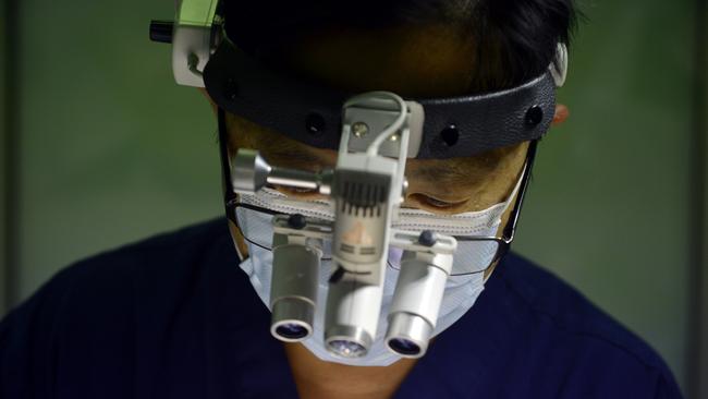 Dr Damien Foong during surgery. Photo: Claudia Baxter / The Queensland Times