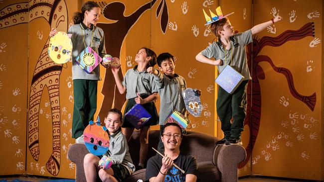 Erskinville Public students Anika Gill (9), Nadia Hammond (9), Harper Dance (9), Isaac Chan (8) and Callan Knox (8) holding the pieces they made for artist Jason Phu’s newest artwork. Picture: Flavio Brancaleone