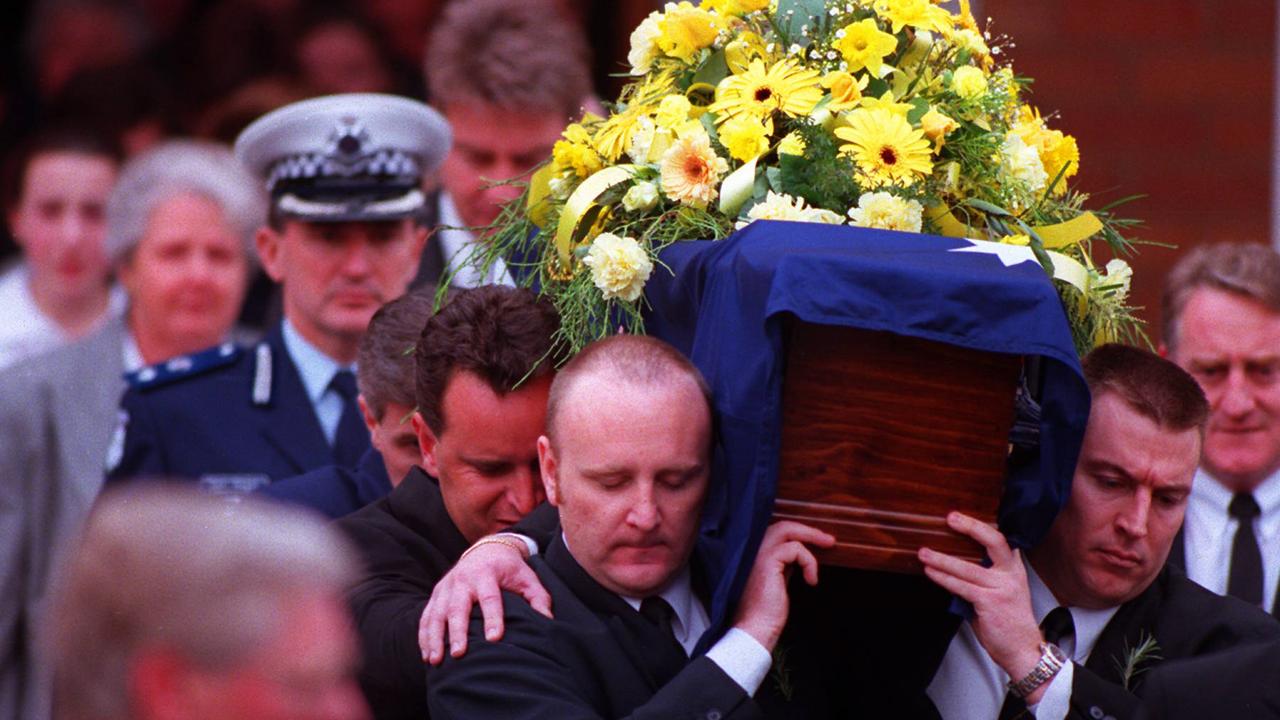 Pallbearers carry Sergeant Silk’s coffin from the Police Academy chapel at his funeral in 1998.