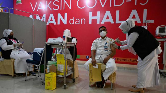 A health worker receives a dose of the Moderna Covid-19 coronavirus vaccine donated by the US, during a booster vaccination drive at the Zainoel Abidin hospital in Banda Aceh on Monday. Picture: Chaideer Mahyuddin