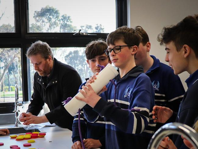 CDM researcher Peter McNamara demonstrates physics to Queensland students. The National Quantum and Dark Matter Road Trip coming to the Territory for the first time in August 2024.