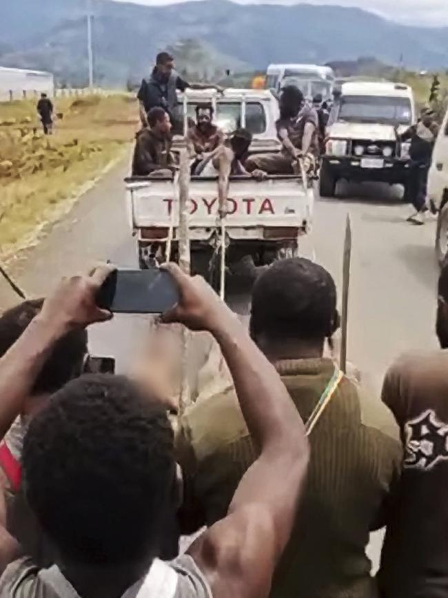 The bodies of killed tribal opponents are dragged by vines tied behind a Toyota ute.