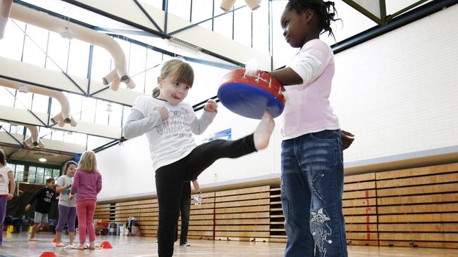 Karate workshop at Croydon Leisure & Aquatic Centre. Caitlyn, 5, lays a kick into Karen, 6.