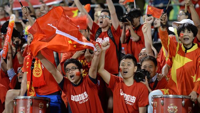 Fans of China cheer during their Group B football match against North Korea in the AFC Asian Cup in Canberra on January 18, 2015. AFP PHOTO/Peter PARKS --IMAGE RESTRICTED TO EDITORIAL USE - STRICTLY NO COMMERCIAL USE