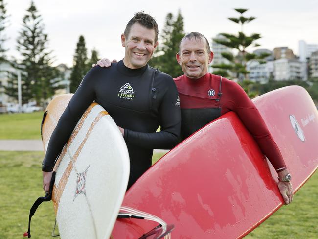 Tony Abbott and Mike Baird have a surf the day before the election at North Steyne. Picture: Braden Fastier