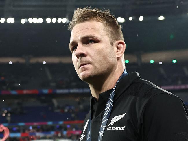 TOPSHOT - New Zealand's openside flanker and captain Sam Cane walks on the field with his silver medal after South Africa won the France 2023 Rugby World Cup Final match between New Zealand and South Africa at the Stade de France in Saint-Denis, on the outskirts of Paris, on October 28, 2023. (Photo by Anne-Christine POUJOULAT / AFP)