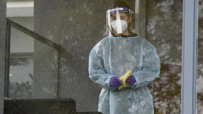 A worker wearing full PPE cleans surfaces at Arcare Maidstone Aged Care in Melbourne's west. Picture: NCA NewsWire / Andrew Henshaw