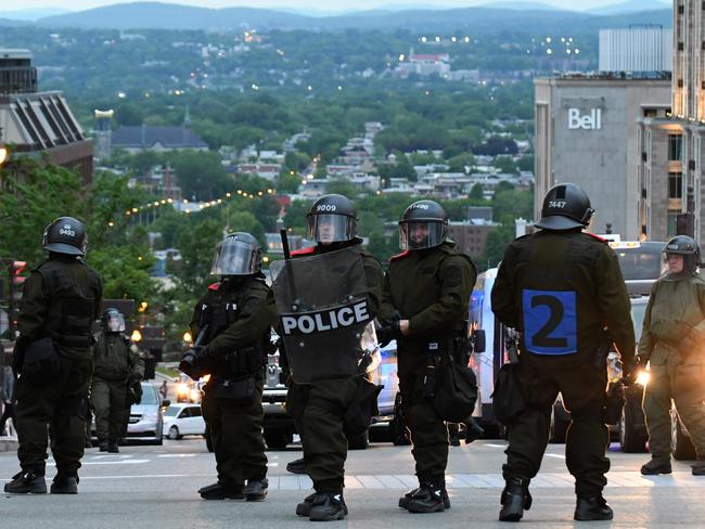 Riot police look on during an anti-G7 demonstration in Quebec City. Picture: AFP / Martin Ouellet-Diotte