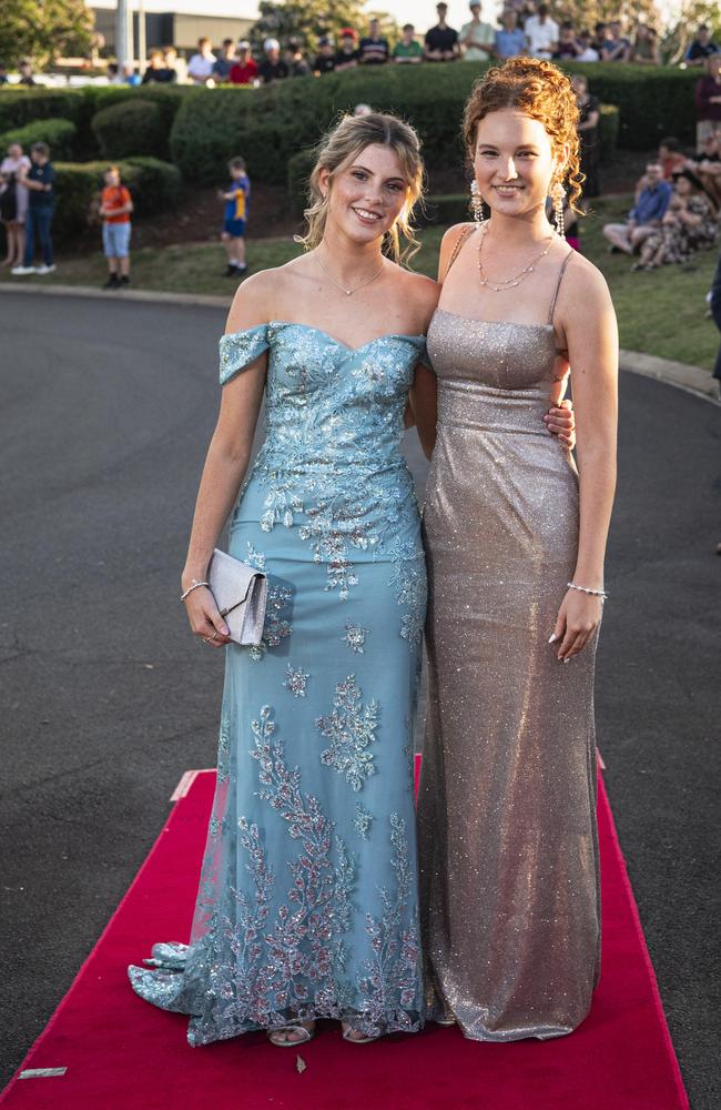 Graduates Chloe Gillett (left) and Chloe Green arrive at Mary MacKillop Catholic College formal at Highfields Cultural Centre, Thursday, November 14, 2024. Picture: Kevin Farmer