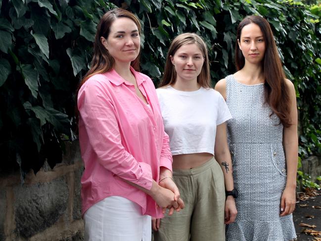 Kateryna Odarushenko, 36, her sister Yelyzaveta "Liza" Komar, 24, and Australian Federation of Ukrainian Organisations co-chair Kateryna  Argyrou. Liza Komar and Kateryna Odarushenko were reunited in Sydney after two and a half years, with Kateryna leaving Ukraine at the beginning of the Russian invasion, while Liza joined the Ukrainian Defence Force as a combat medic. Picture: James Dowling/The Australian