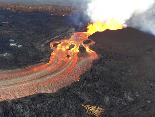 Fissure 8 below Kilauea Volcano continues to erupt vigorously with lava streaming through a channel that reaches the ocean at Kapoho Bay. Picture: U.S. Geological Survey via AP