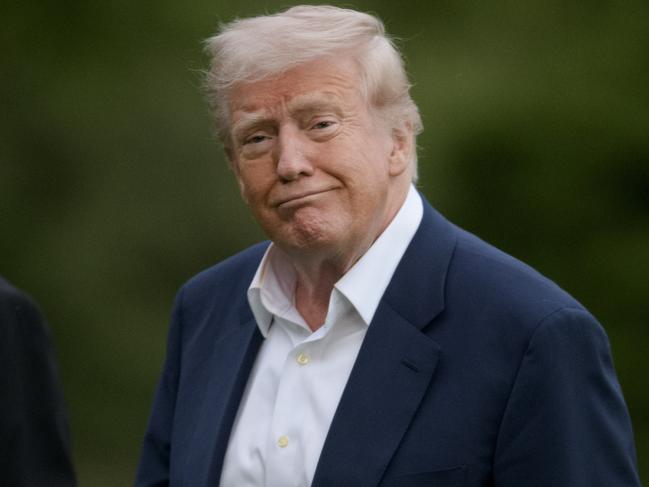 President Donald Trump, right, is joined by first lady Melania Trump's father Viktor Knavs, as they disembark Marine One upon arrival on the South Lawn of the White House in Washington, Sunday, May 4, 2025. (AP Photo/Rod Lamkey, Jr.)