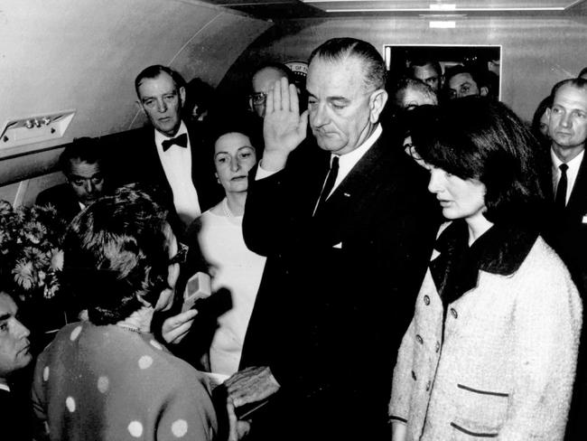 USA politician President Lyndon B. Johnson (c)with wife Lady Bird Johnson (3rd l) and former First Lady Jacqueline Kennedy during his swearing in ceremony in the cabin of the presidential plane 22 Nov 1963.