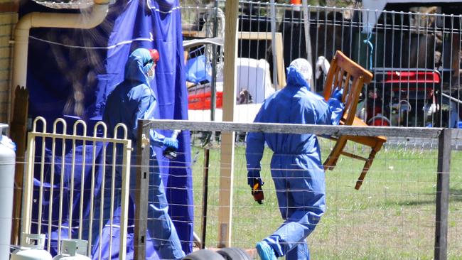 Police remove a chair at the home of Rick Thorburn. Pic Darren England.