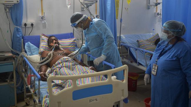 A doctor checks on a Covid-19 patient in the Intensive Care Unit (ICU) of the Nightingale Hospital, on the outskirts of Siliguri, India. Picture: AFP