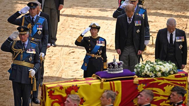 Prince Charles, Prince William, and Princess Anne salute the Queen as Prince Harry and Prince Andrew bow their heads. Picture: Getty Images