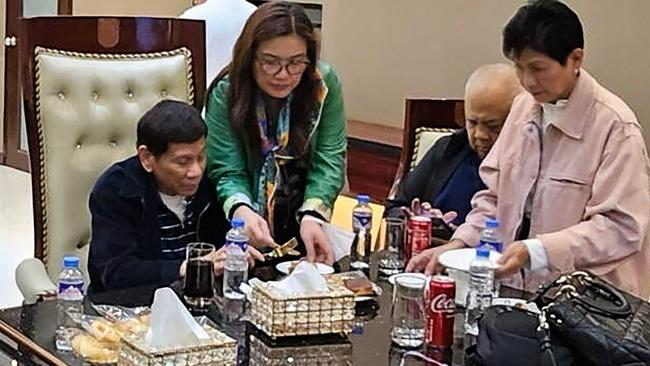 Former Philippines president Rodrigo Duterte, left, at Villamor Air Base in Manila after arriving from Hong Kong. Picture: AFP