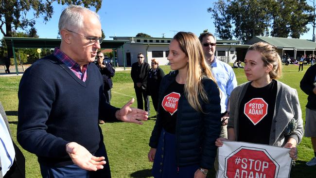 Prime Minister Malcolm Turnbull being confronted by anti Adani coal mine protesters in Caboolture, Saturday. Picture: AAP