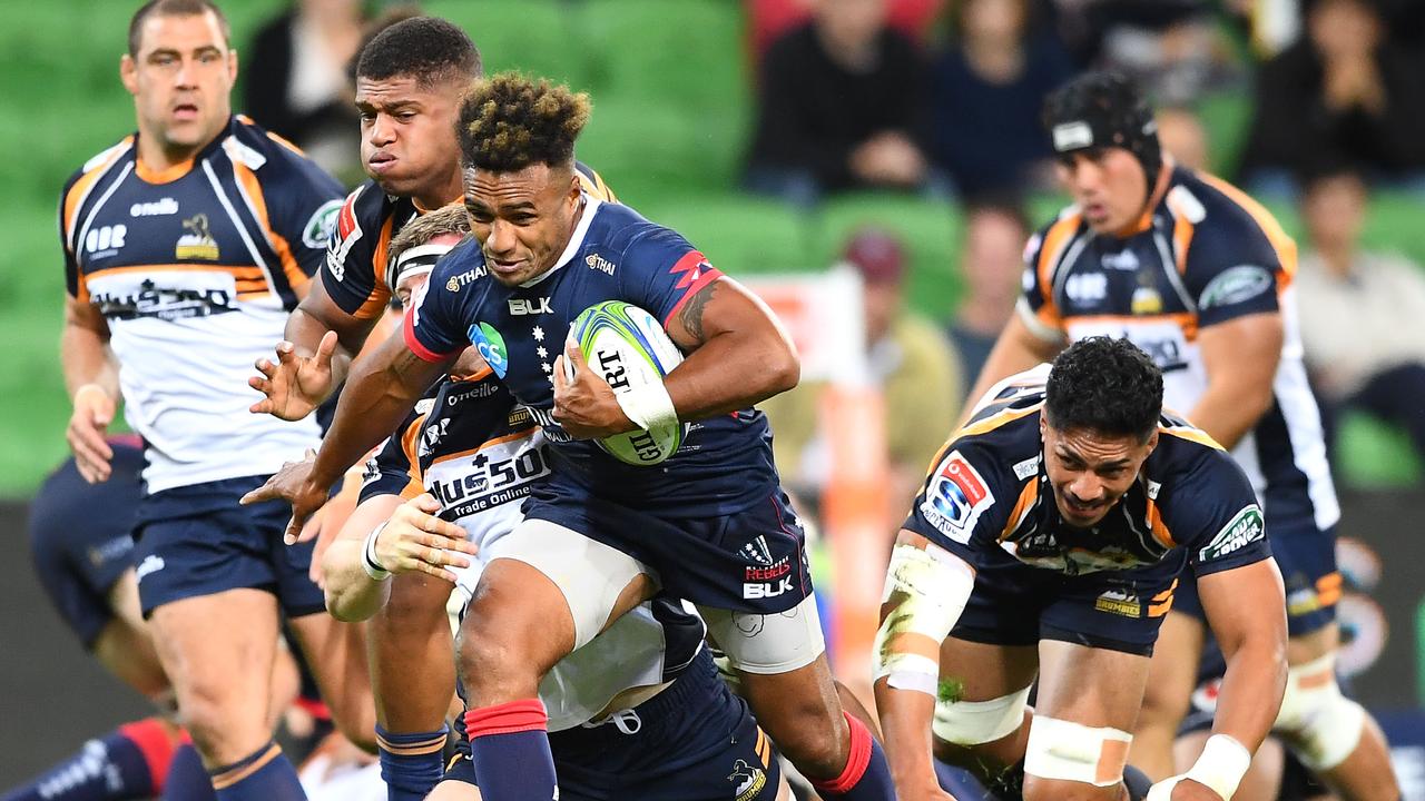 Will Genia of the Rebels breaks free of a tackle at AAMI Park in Melbourne.