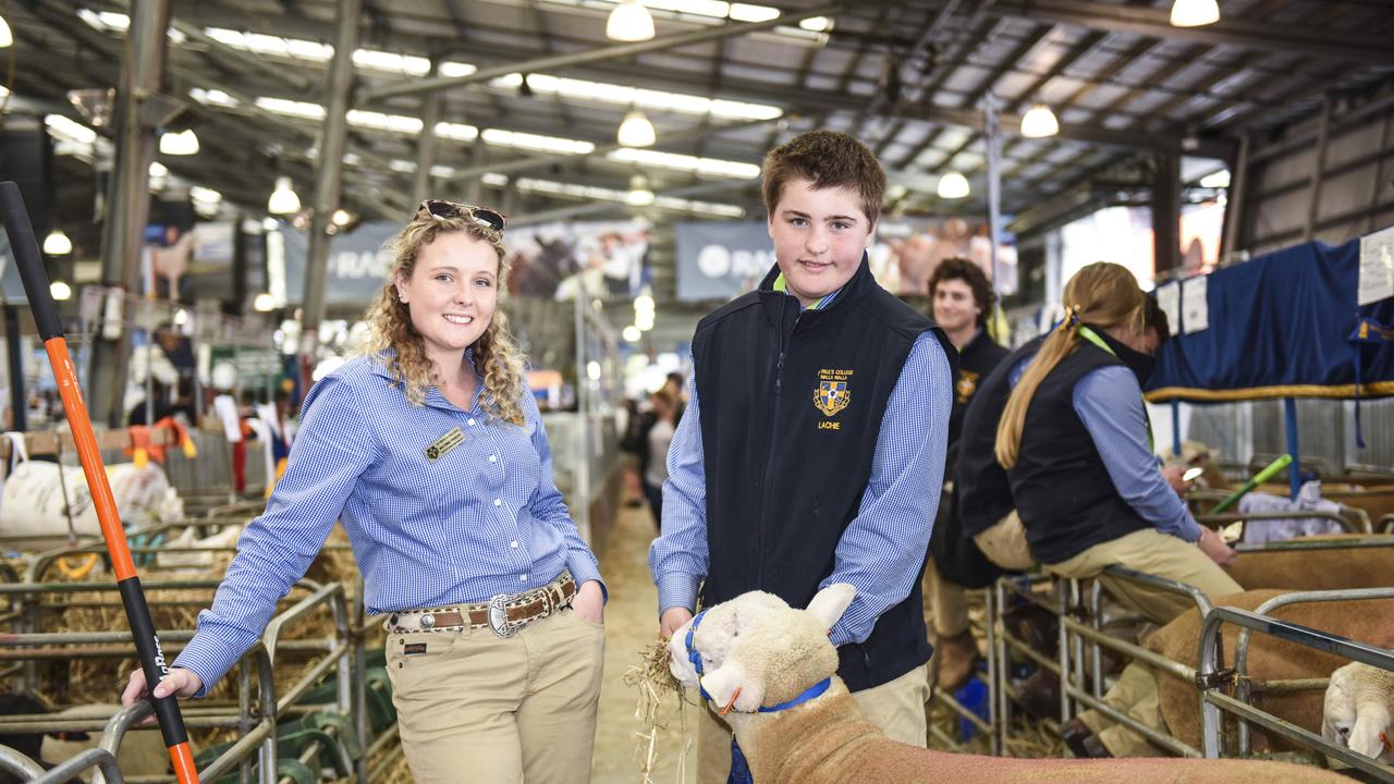 St Pauls College livestock manager Emma Finemore from Walla Walla, NSW, with student Lachie Routley, 12 from Urana, NSW, at the Royal Melbourne Show. Photo: Dannika Bonser