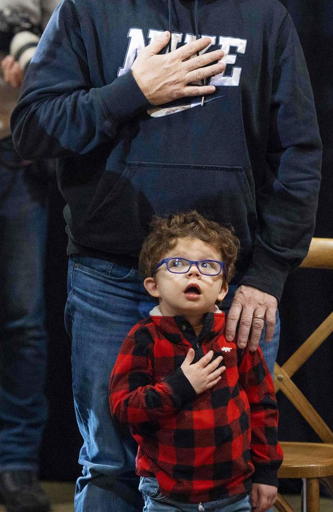 A young supporter shows respect during national anthem at Ron DeSantis’ campaign event in Davenport, Iowa. Picture: Christian Monterrosa/AFP