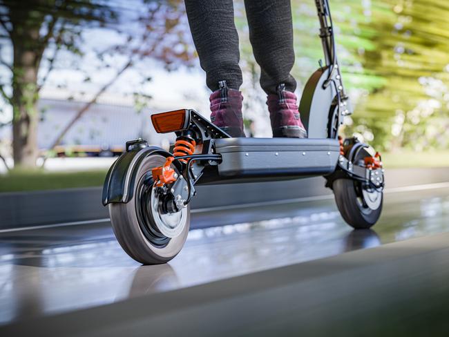 Electric scooter fast ride through the city - closeup to back wheel, motion blur effect. Picture: istock