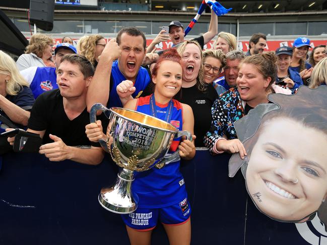 Western Bulldog Jenna Bruton celebrates 2018 AFLW grand final win with fans.