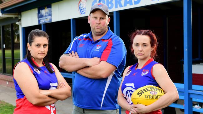 Cove women’s footballers Josie Smith (L) and captain Dana O’Brien with coach Brett Baldey (C). The trio has rubbished claims of sexual harassment at the club which led to Marion Council booting it out of its southern suburbs home. Picture: AAP/Mark Brake