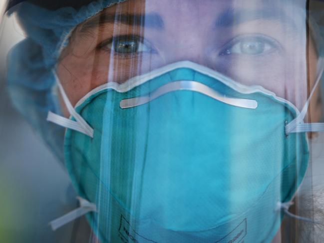 SYDNEY, AUSTRALIA - JULY 22: Registered Nurse Ali Murphy is seen wearing PPE (Personal Protective Equipment) at a Bondi Beach COVID-19 drive-through testing clinic on July 22, 2020 in Sydney, Australia. New South Wales recorded 16 new COVID-19 cases on Wednesday, bringing the state's total number of coronavirus cases to 3,425. NSW residents are being urged to avoid non-essential travel and large crowds, as health authorities work to contain several COVID-19 cluster outbreaks across the state. Cases linked to the Crossroads Hotel, Thai Rock and Batemans Bay Soldiers Club clusters have been shown to all be linked to virus strains in Victoria, where residents are currently in lockdown due to the dramatic rise in community transmissions. (Photo by Lisa Maree Williams/Getty Images)