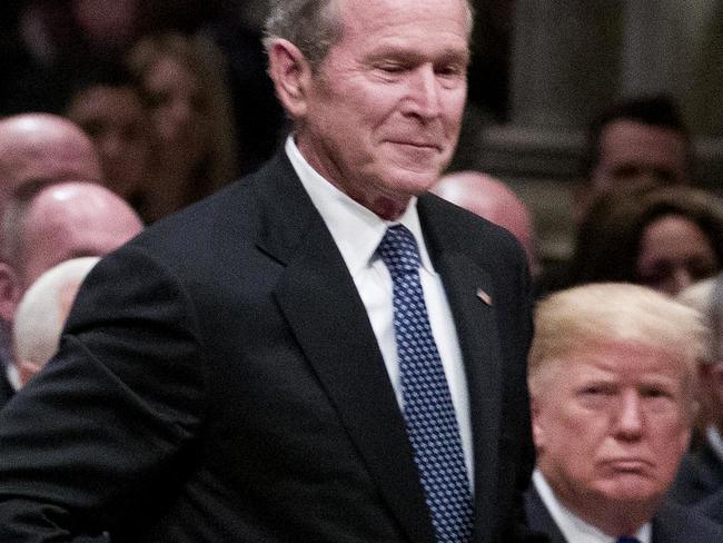 Former President George W. Bush walks past President Donald Trump. Joe Biden referred to Mr Trump as “George” in an online address. Picture: AFP