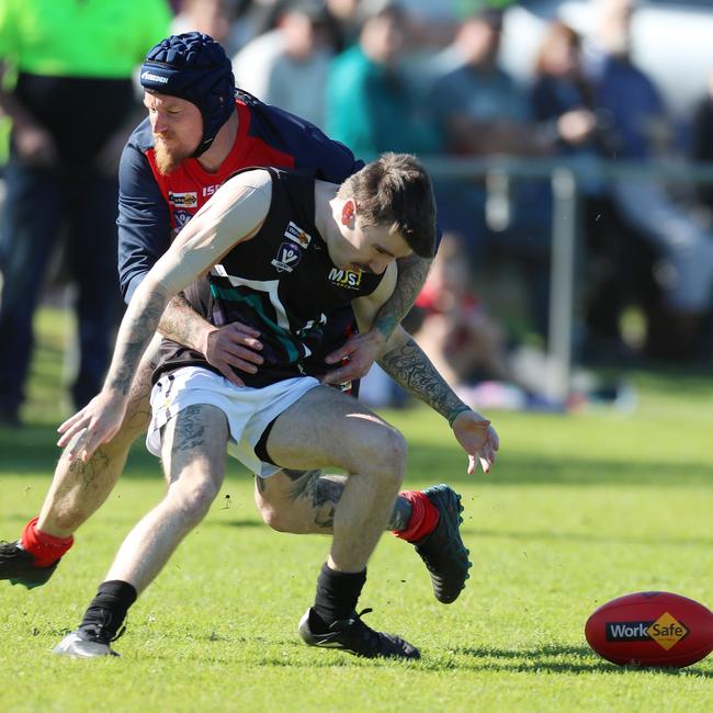 Swifts Creek’s Patrick Cusack tackles Omeo-Benambra’s Jacob Tomkins without the ball.