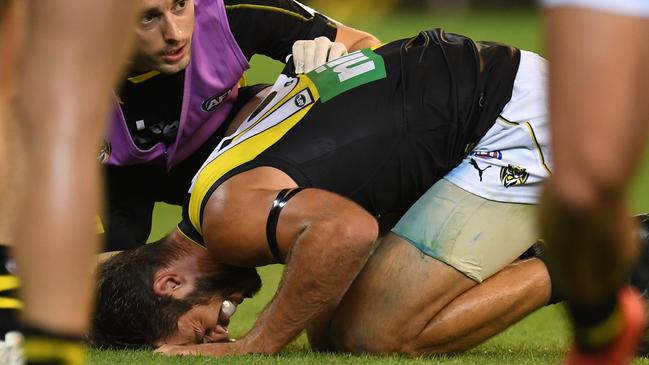 Alex Rance in pain after injuring his knee against Carlton.