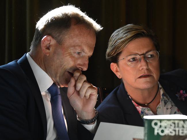 Former prime minister Tony Abbott (left) and Christine Forster sign copies during the launch of Forster's new book in Sydney, Thursday, June 11, 2020. (AAP Image/Joel Carrett) NO ARCHIVING