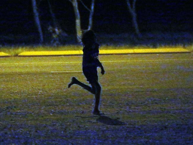 A young girl runs past a petrol station in Tennant Creek. Children as young as seven roam the streets in Tennant Creek NT. From 10pm through to the early hours of the morning children were spotted wondering the streets. Some as young as 11 years old.Picture Gary Ramage