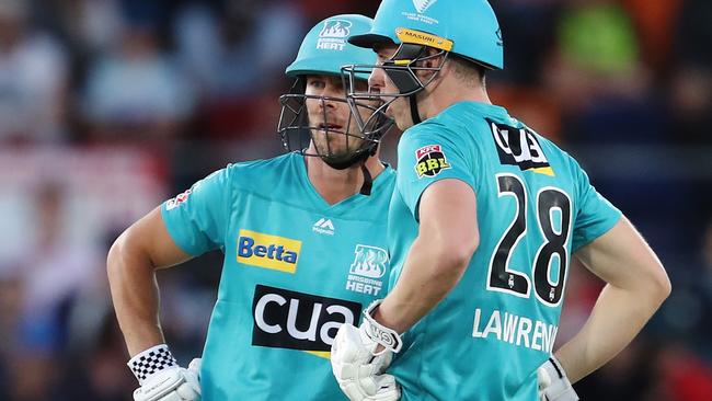 CANBERRA, AUSTRALIA - DECEMBER 14: Chris Lynn and Dan Lawrence of the Heat chat during the Big Bash League match between the Sydney Thunder and the Brisbane Heat at Manuka Oval, on December 14, 2020, in Canberra, Australia. (Photo by Brendon Thorne/Getty Images)