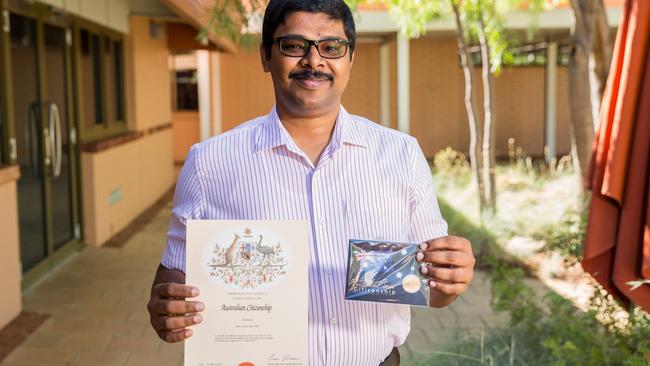 New Australian citizen Nibu Baby with his certificate. Picture: Emma Murray