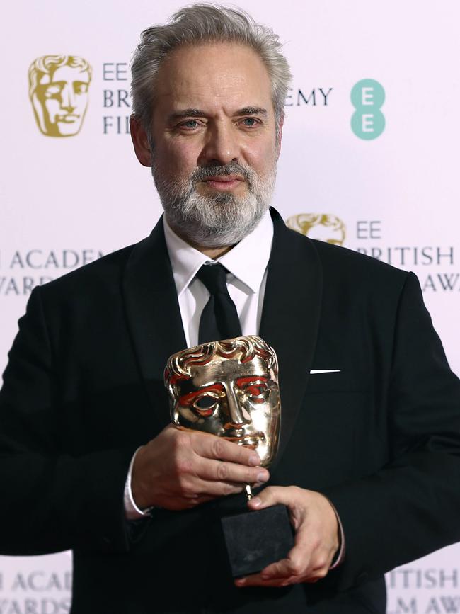 Director Sam Mendes poses with the Best Director award for 1917.